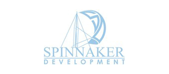 A logo featuring a sailboat with a spinnaker sail in light blue, above the words "SPINNAKER DEVELOPMENT" in uppercase light blue text.