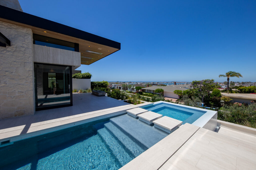 Luxury outdoor stone pool deck installation by Epic Ceramic and Stone in Orange County California