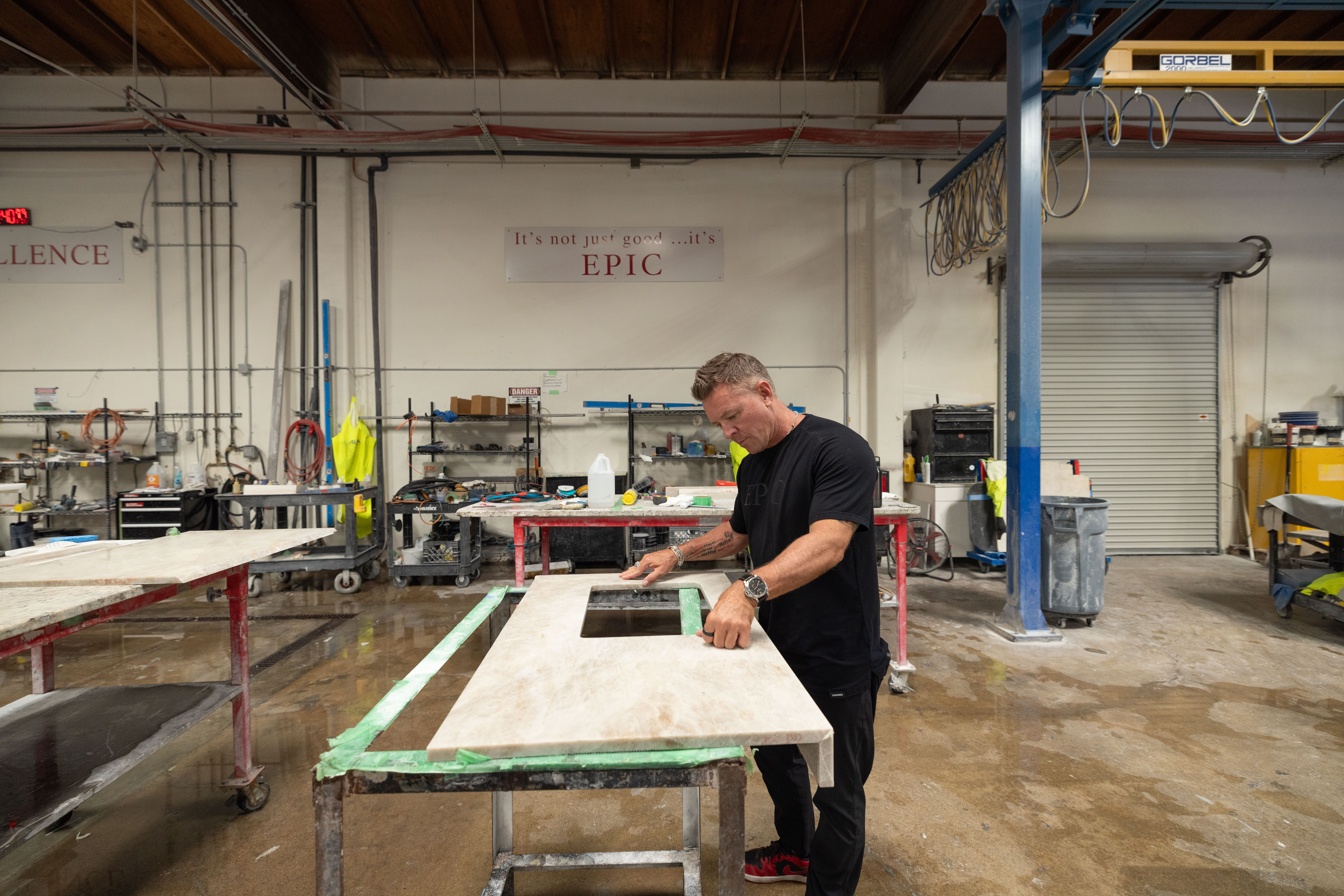 Epic Ceramic & Stone team member reviewing slab layout and digital templating details before fabrication.