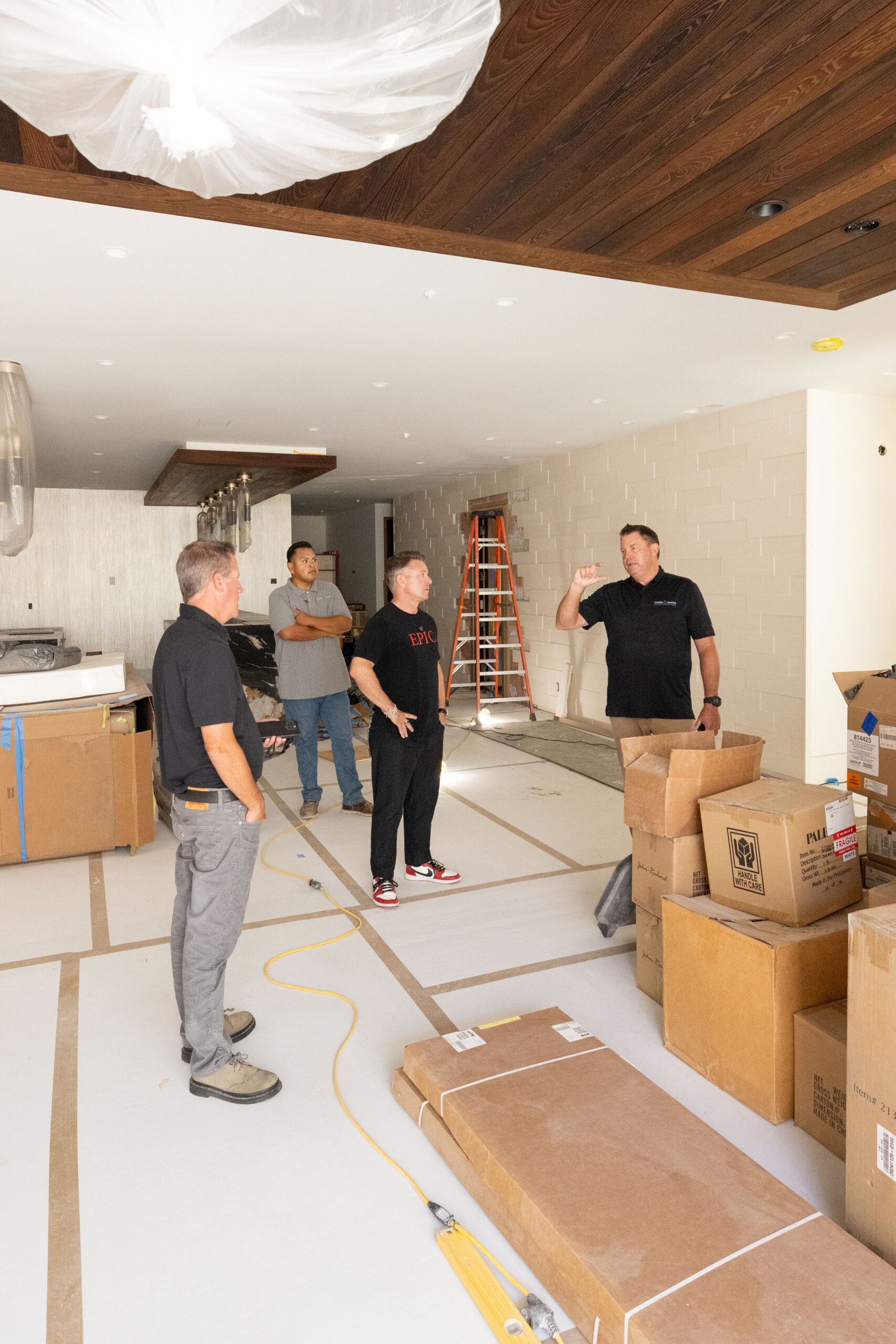 Epic Ceramic & Stone team meeting with project partners during a final walkthrough of a custom residential installation in Orange County.