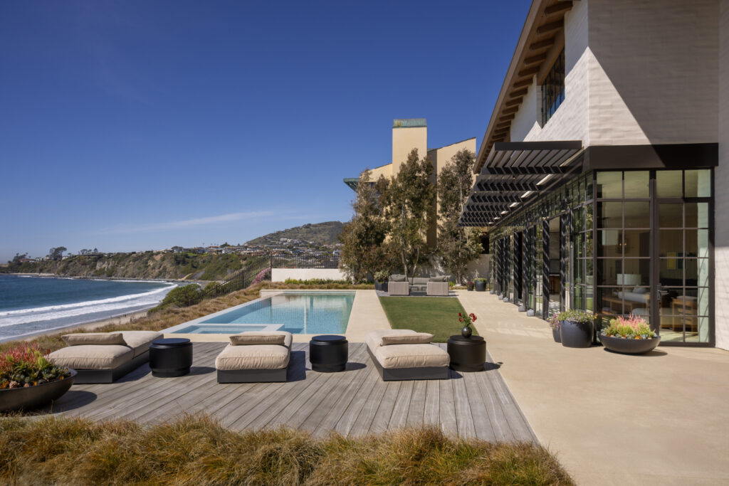 Large-format porcelain and natural travertine pool deck installation in a Southern California outdoor living space.