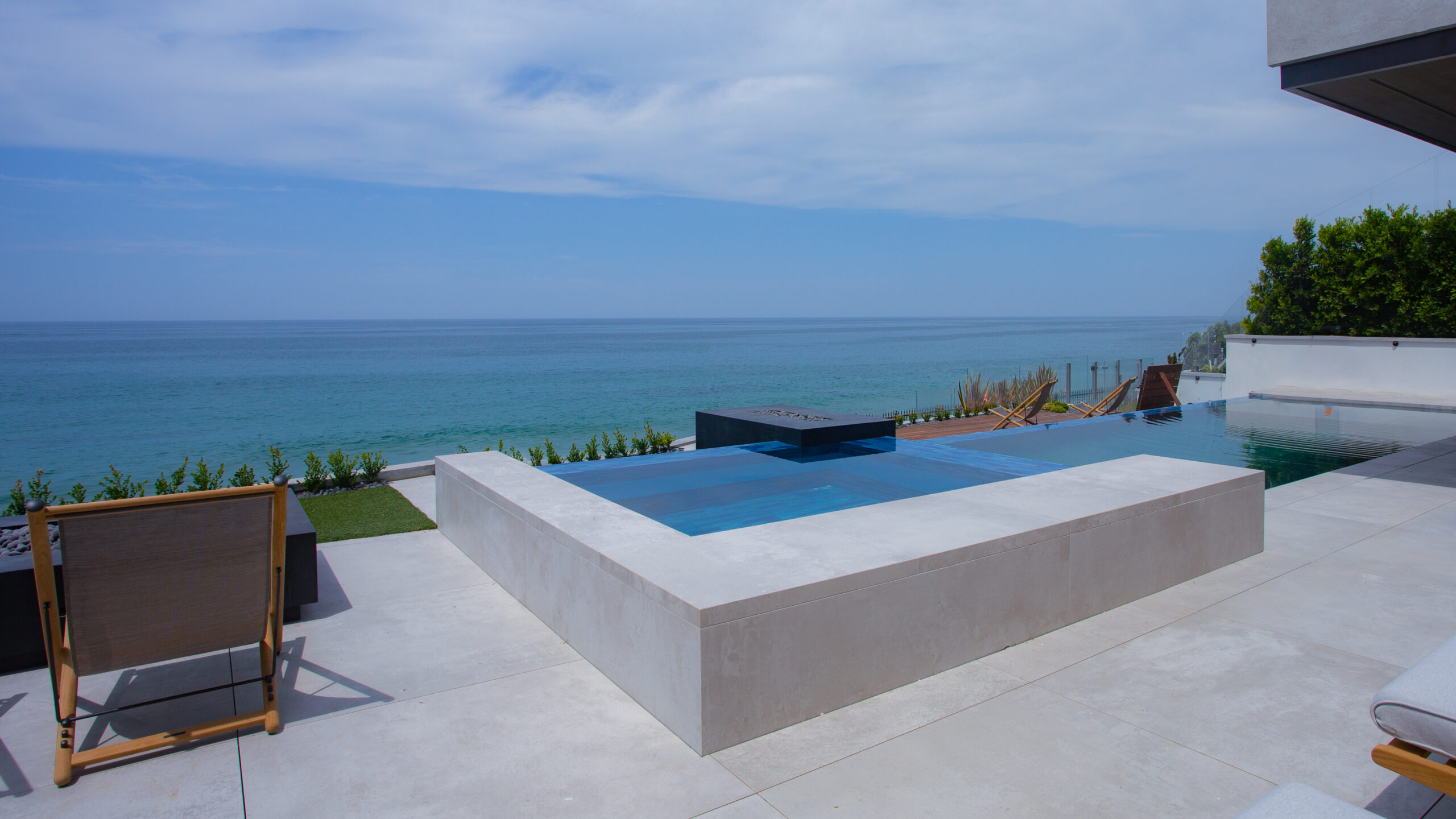 Large-format outdoor pool deck surface overlooking the ocean