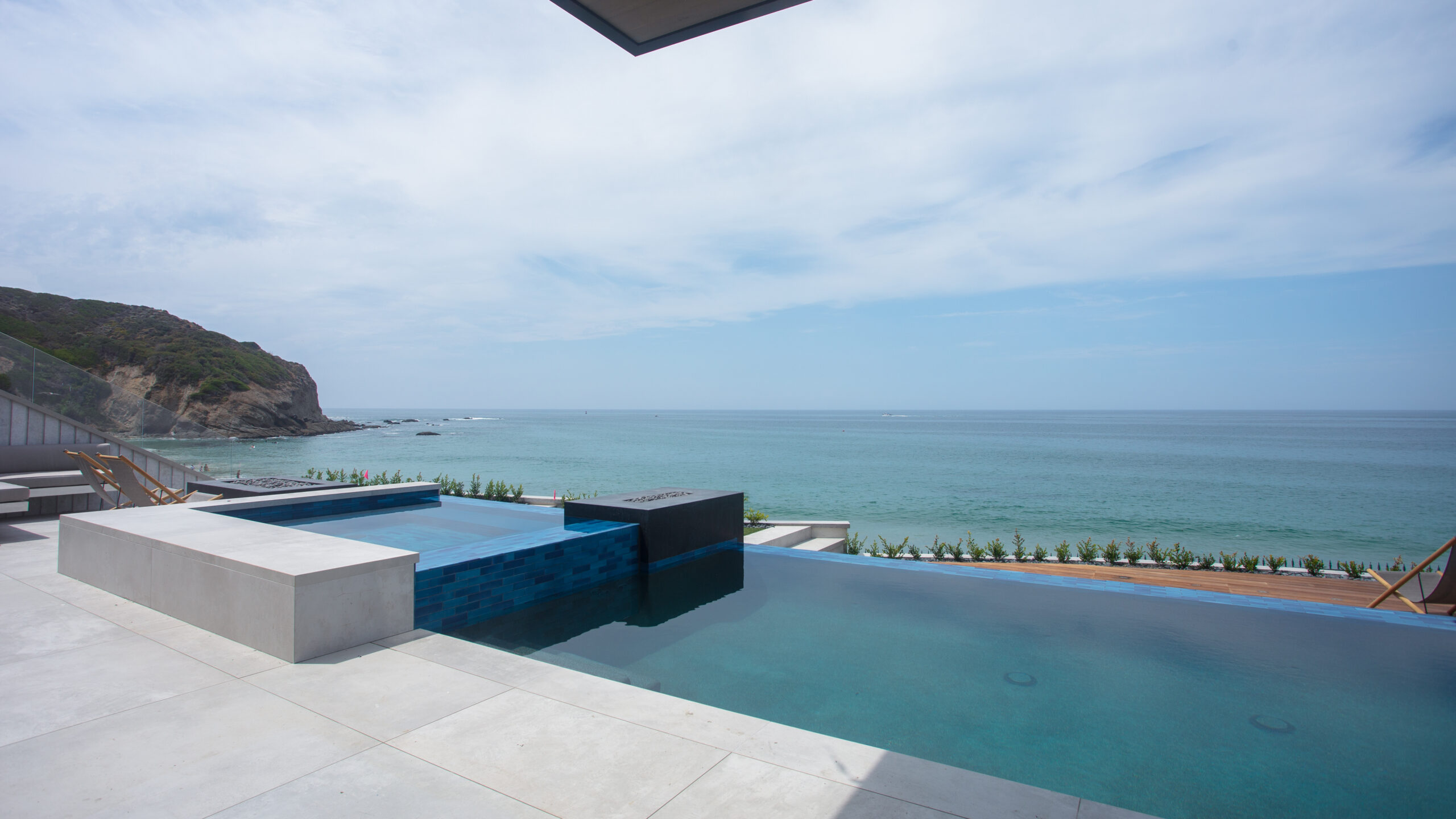 Large-format pool deck overlooking the ocean in Southern California